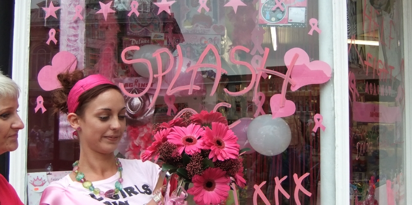 Pink themed shop window and shop assistant with pink flowers and pink clothes