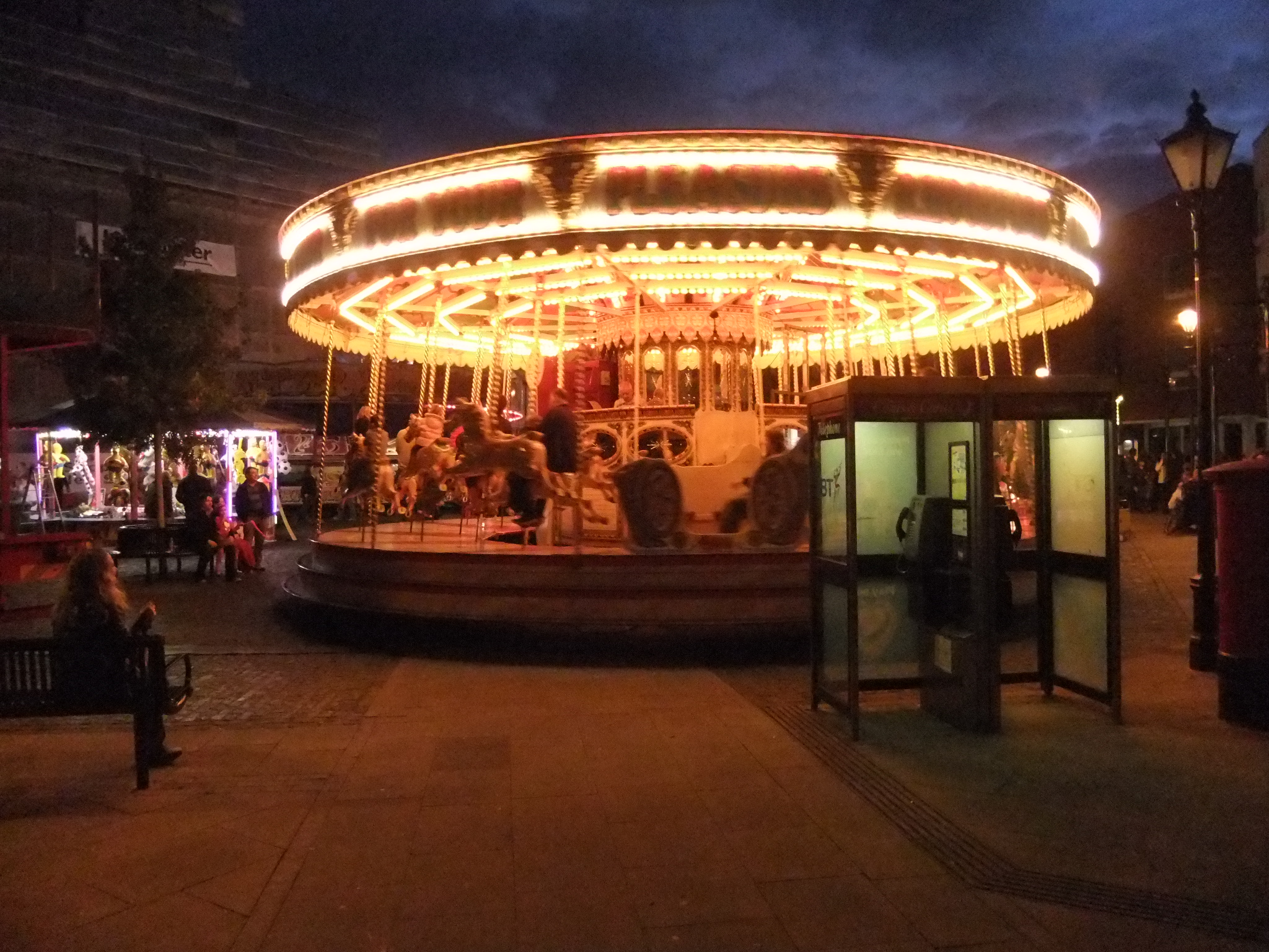 The fairground rides light up the Market Place